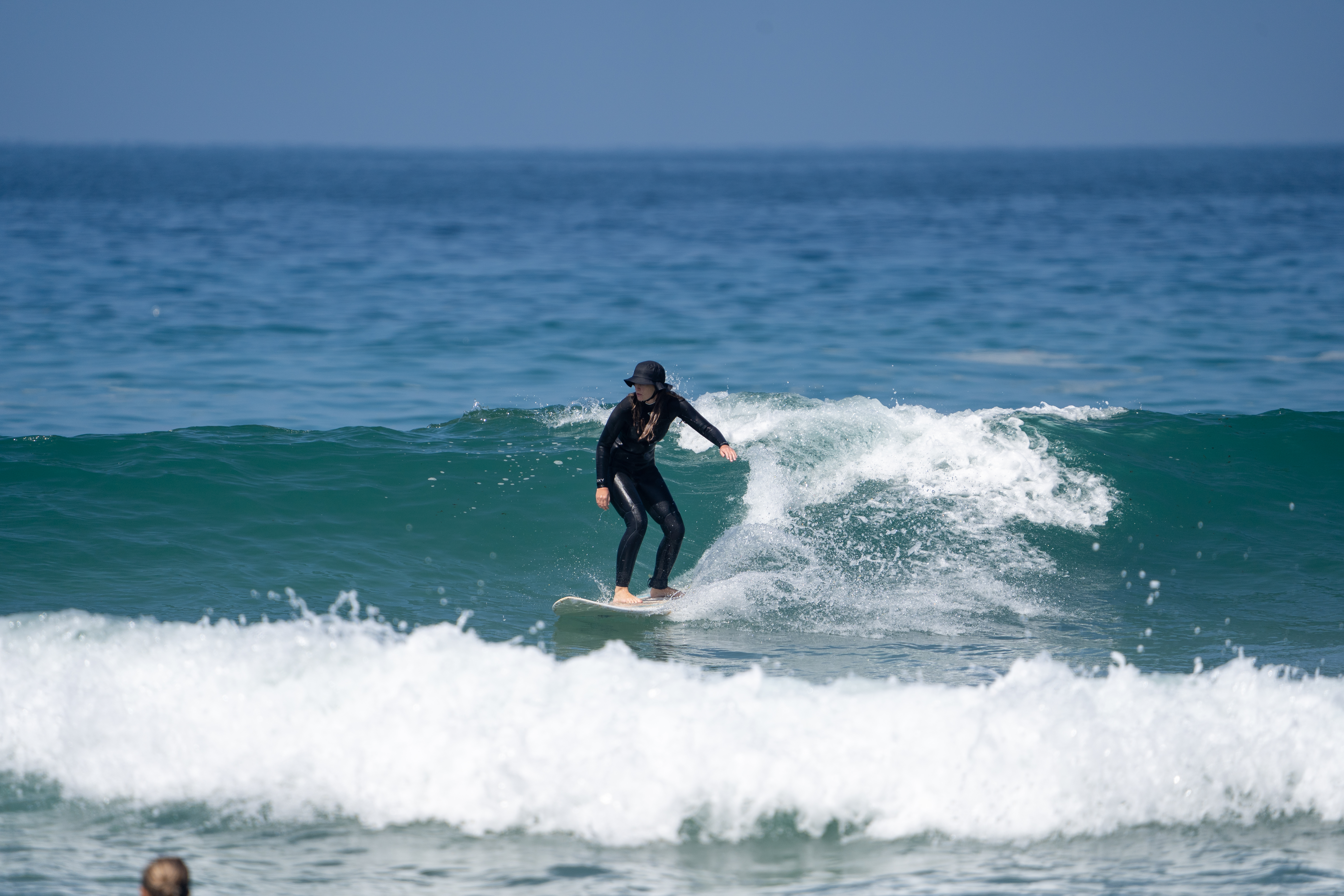 Intermediate surfer riding a wave